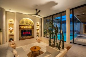 a living room with a couch and a tv at Your Romantic Mediterranean Villa in Canggu in Dalung +54 photos