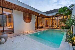 a swimming pool in the backyard of a house at Your Romantic Mediterranean Villa in Canggu in Dalung