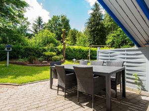 a table and chairs sitting on a patio at 6 person holiday home in Ansager-By Traum in Ansager +17 photos