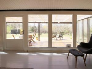 a living room with sliding glass doors and a patio at 4 person holiday home in Jægerspris in Jægerspris