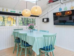 a dining room with a blue table and chairs at 5 person holiday home in Ansager-By Traum in Ansager +12 photos