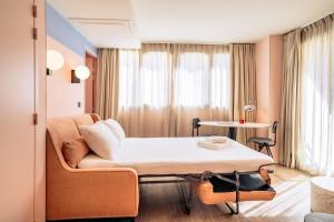 a hospital room with a bed and a couch at RockyPop Marseille Hôtel in Marseille +69 photos