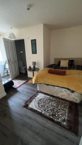 a bedroom with a bed and a rug on the floor at QueensBerry Hotel in Annan +3 photos