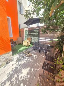 a patio with a wooden bench and an umbrella at 4 Apartments Angels o k b in Altenburg