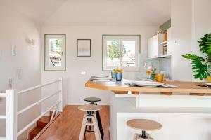 a kitchen with a counter and stools in a room at Piazza San Giacomo - Attico su due livelli in Udine