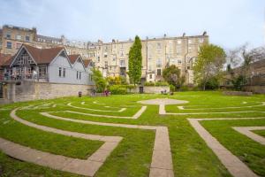 a garden in front of a large building at 2 Bed in Bath oc-bhr35 in Bath
