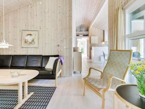 a living room with a couch and a table at 4 star holiday home in Ålbæk in Ålbæk