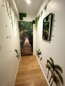 a hallway with a mural on the wall at Maison climatisée Lyon-Bron Eurexpo - Stadium Groupama - Interdit aux événements in Bron