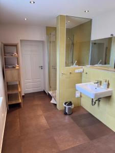 a bathroom with a sink and a mirror at Ferienhaus Niemtsch -Alte Schule- in Senftenberg +12 photos