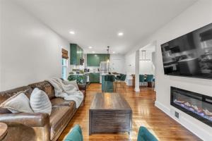a living room with a couch and a fireplace at The Treehouse at Treetown by Granger Gardens in Ann Arbor +28 photos