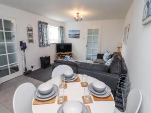 a living room with a couch and a table at 51 Longstone Park in Chathill