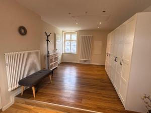 an empty hallway with a bench in the middle of a room at Ferienhaus Niemtsch -Alte Schule- in Senftenberg