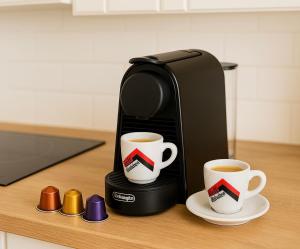 a coffee maker with two cups on a table at Gîte du Moulin de Maître Pierre in Payrignac +30 photos