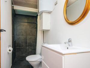 a bathroom with a toilet and a sink and a mirror at 5 person holiday home in Odder in Odder +18 photos