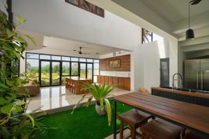 a kitchen and living room with a wooden table at Polaris- Kurunegala in Kurunegala