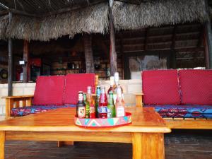 a wooden table with bottles of alcohol on it at Silver Fish Resort in Maxixe