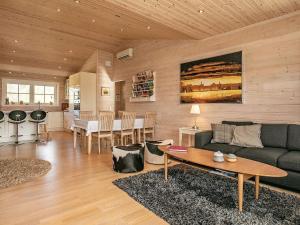a living room with a couch and a table at 5 star holiday home in Spøttrup in Spottrup