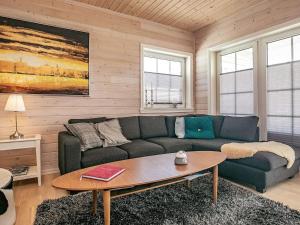 a living room with a couch and a table at 5 star holiday home in Spøttrup in Spottrup +31 photos