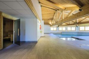 an empty room with a swimming pool in a building at C03 lajoue in Le Dévoluy