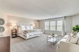 a large bedroom with a bed and a couch at Lavish HUGE Noblesville and Carmel adjacent family home in Noblesville