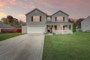 a large house with a driveway in a yard at Lavish HUGE Noblesville and Carmel adjacent family home in Noblesville