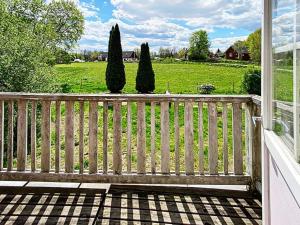 une véranda avec une clôture en bois et des arbres dans l'établissement 7 person holiday home in ÄLMEDBODA, à Älmeboda