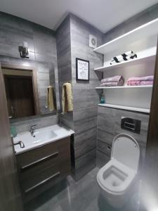 a bathroom with a white toilet and a sink at Beachside Apartment in Mohammedia +43 photos