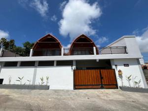 a white house with two domes on top of it at Rumah Harmoni in Ungasan