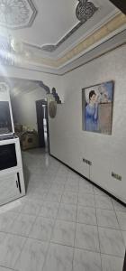 a living room with a painting on the wall at دار الوقار in Tangier