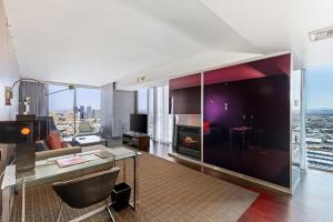 a living room with a glass table and a fireplace at Palms Place Condo Hotel & Casino in Las Vegas