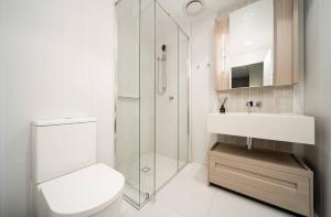 a bathroom with a toilet and a sink and a shower at Skyscraper Cinema - Dream a thousand city lights in Brisbane +17 photos