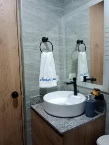 a bathroom with a white sink and a mirror at Apartamento cerca el mar sunset 47 in Cartagena de Indias +22 photos