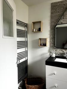 a bathroom with a tv on a wall at Fécamp Beachfront House in Fécamp +31 photos