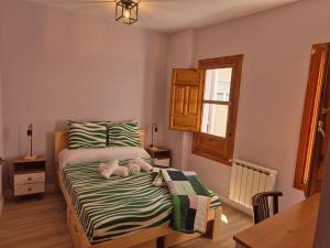 a bedroom with a bed with two stuffed animals on it at Posada de la Luna in Granada