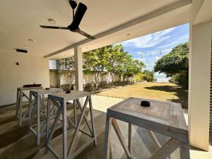 a room with four tables and a ceiling fan at 234 Weligama in Weligama