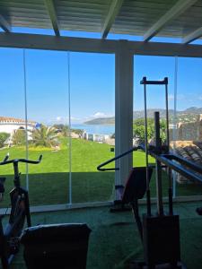 a gym with a view of a large window at Villa Di Fiore - private villa up to 10 guests with pool sauna and gym in Geremeas