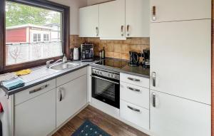 a kitchen with white cabinets and a sink and a window at Amazing Home In Meschede With Wifi in Meschede