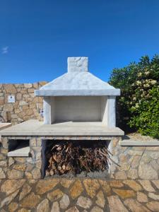 a stone bench sitting on top of a stone wall at Villa Di Fiore - private villa up to 10 guests with pool sauna and gym in Geremeas