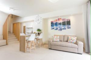 a living room with a couch and a table at Fortaleza Rooms Pefkochori in Pefkochori