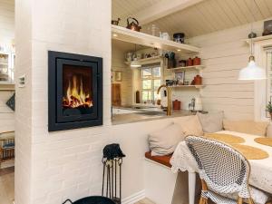 a living room with a fireplace on the wall at Cozy Beach House - By Traum Ferienwohnungen in Jerup