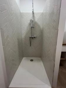a shower stall with a cross on the wall at Les Murmures du Palais - Terrasse privée avec vue in Avignon +7 photos