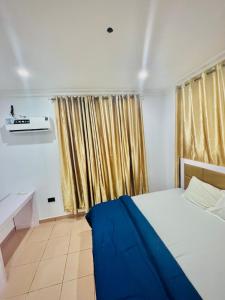 a bedroom with a bed and a window with curtains at 3 Bedroom in Lekki Lagos in Lekki