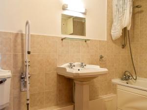 a bathroom with a sink and a shower at Lower Chinkwell-Uk12426 in Widecombe in the Moor +12 photos