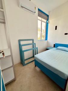 a bedroom with a blue bed and a window at 234 Weligama in Weligama