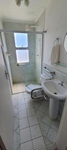 a bathroom with a sink and a toilet and a shower at Hotel Casa Enseada Guarujá in Guarujá +17 photos