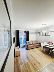 a living room with a couch and a table at TK Apartments Spiżowa in Wrocław