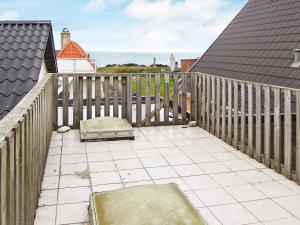 a balcony with a dog bed and the ocean at 6 person holiday home in Lemvig-By Traum in Ferring