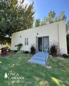 a white building with stairs in front of it at Cabañas Finca Casiana in Santa Lucía