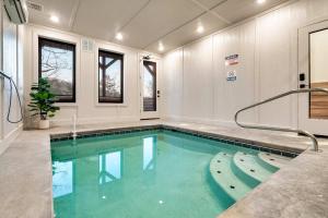 a large swimming pool in a room with windows at Modern Luxury Pool Hot Tub & Near Water Parks in Sevierville