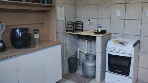 a small kitchen with a stove and a counter at 23 - Este imovel e seu disponha a vontade in Paragominas